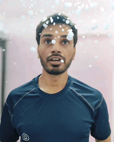 Man With Snowflakes on Face in Blue Shirt