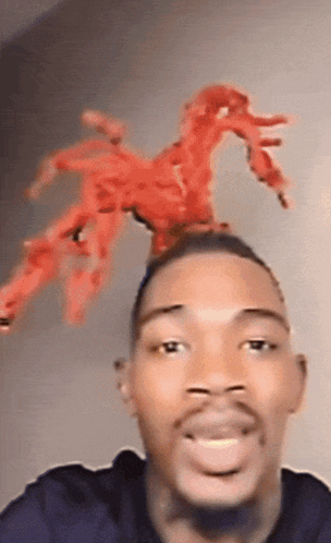 Man With Spider On Head Looking At Camera GIF