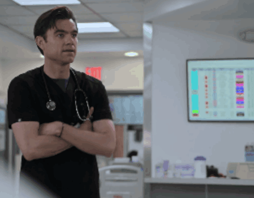 Man with Stethoscope in Front of Exit Sign