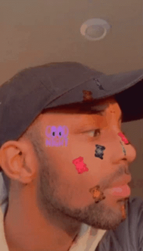 Man with Stickers on Face Wearing Hat