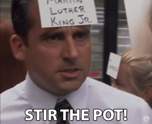 Man with Stir the Pot Sign