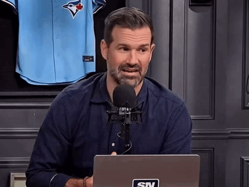 Man With STV Sticker On Laptop At Microphone GIF