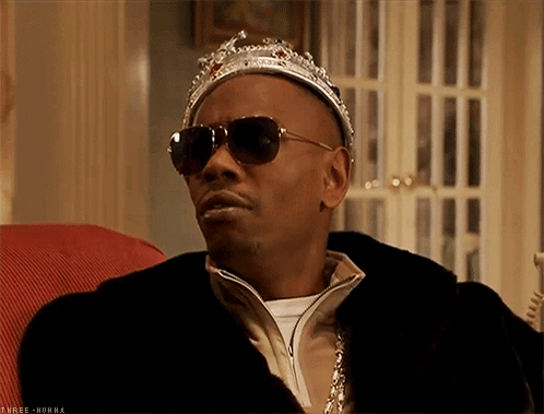Man With Sunglasses and Crown Sitting