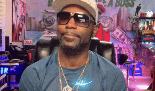 Man with Sunglasses and Hat at On Air Sign