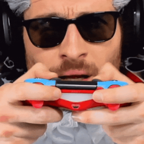Man With Sunglasses And Headphones Holding Video Game Controller GIF