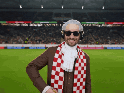 Man With Sunglasses and Scarf at Soccer Field