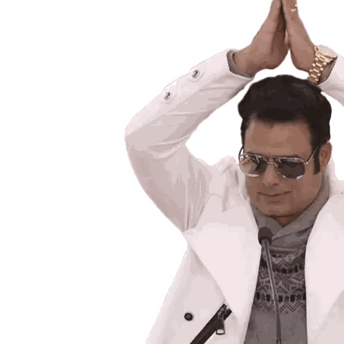 Man With Sunglasses and White Coat Raises Hands