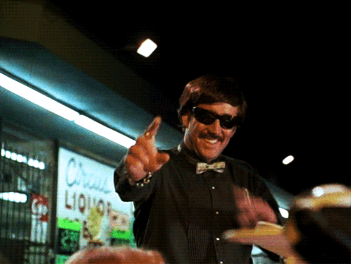 Man With Sunglasses in Front of Liquor Store