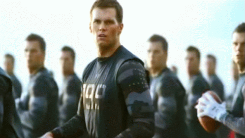 Man With Tac Shirt and Group of Men