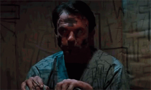 Man With Tape On Face By Graffiti Wall GIF