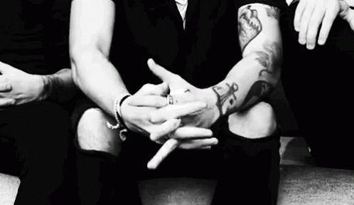 Man With Tattoo Cracking Knuckles GIF
