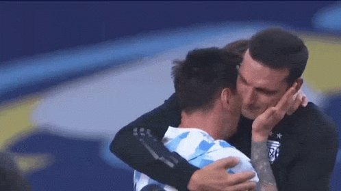 Man with Tattoo Hugging Soccer Player