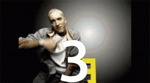 Man With Tattoo Pointing to Number Three