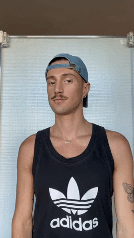 Man With Tattoo Shrugs GIF