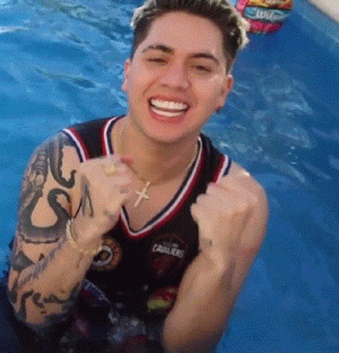 Man with Tattoo Smiling in Pool