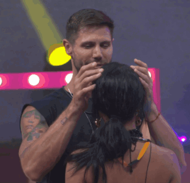 Man With Tattoo Touching Woman's Head
