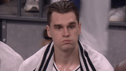 Man With Towel Around Neck Looks Tired