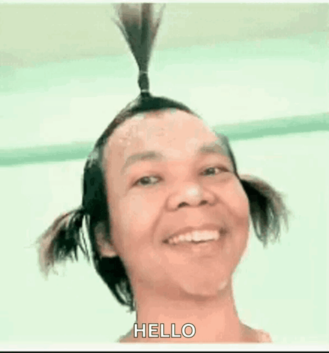 Man With Two Pigtails Smiling Saying Hello
