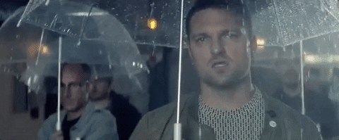 Man With Umbrella Staring Seriously GIF