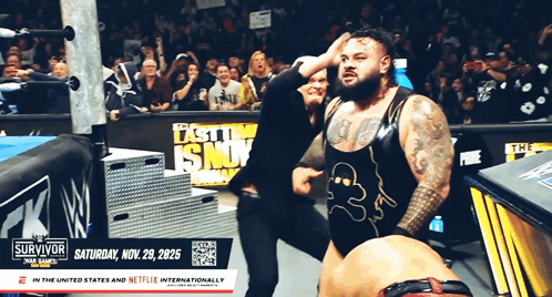 Man With W Logo Shirt at Wrestling Event