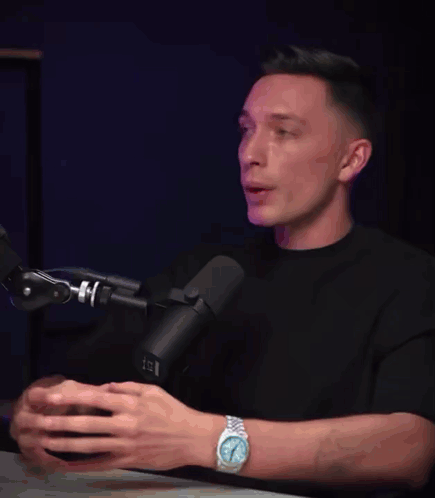 Man With Watch at Microphone Saying Brother Just Wait