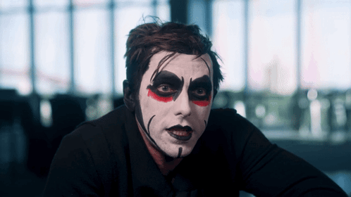 Man with White Face Paint and Red Eyes