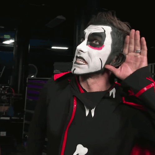 Man with White Face Paint in Black and Red Jacket