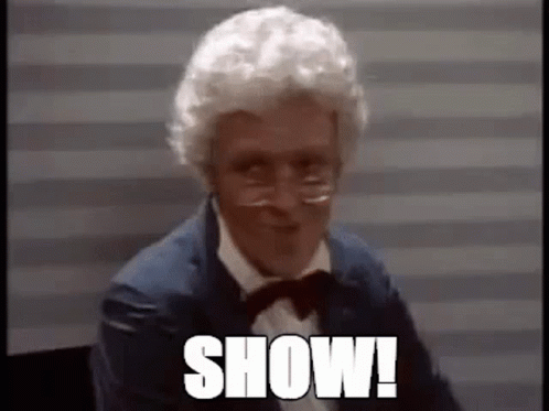 Man With White Hair And Glasses In Suit And Bow Tie Saying Show GIF