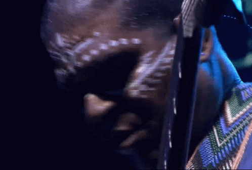 Man With White Paint On Face Looking Down GIF