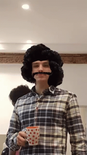 Man With Wig And Mustache Holding Cup GIF