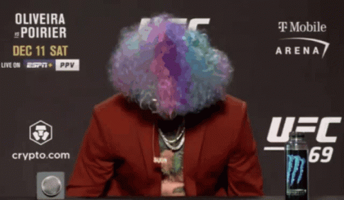 Man With Wig And Sunglasses In Front Of UFC Sign GIF