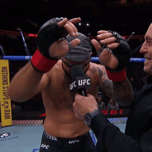Man With Wig And Sunglasses In Front Of UFC Sign GIF