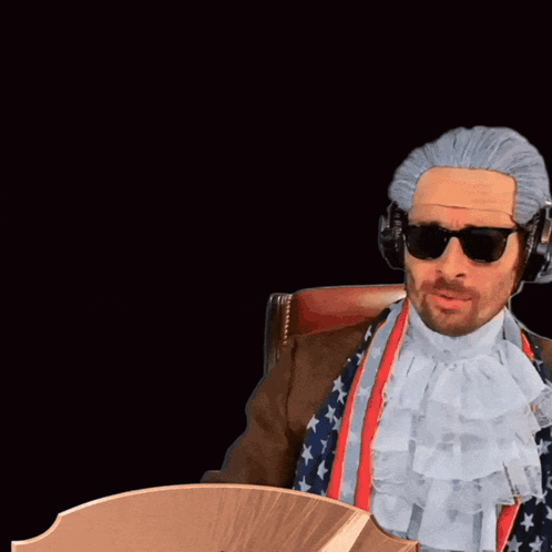 Man With Wig and Sunglasses Next to Card Saying RW Cam