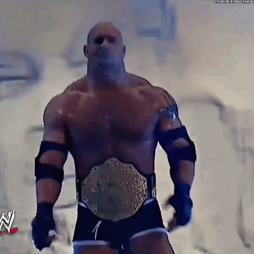 Man With Wrestling Belt Standing in Front of N Sign