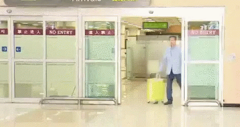 Man With Yellow Suitcase At No Entry Gate GIF