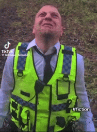 Man with Yellow Vest and Tie Looking Skyward