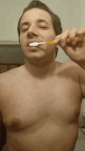 Man Without Shirt Brushing Teeth