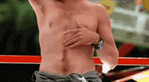 Man Without Shirt Holding Chest In Boxing Ring GIF