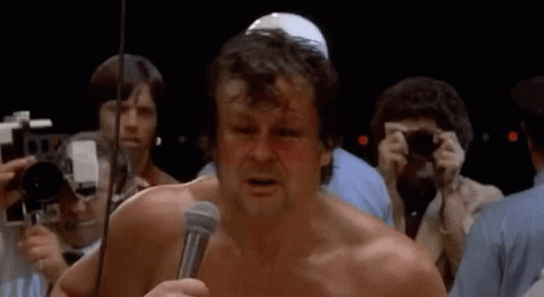 Man Without Shirt Holding Microphone