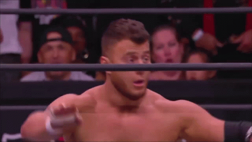 Man Without Shirt in Wrestling Ring With Crowd