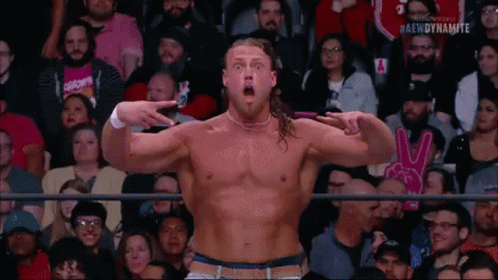Man Without Shirt Pointing At Camera In Crowd GIF