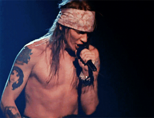 Man Without Shirt Singing Into Microphone GIF