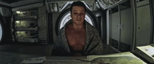 Man Without Shirt Sitting At Table GIF