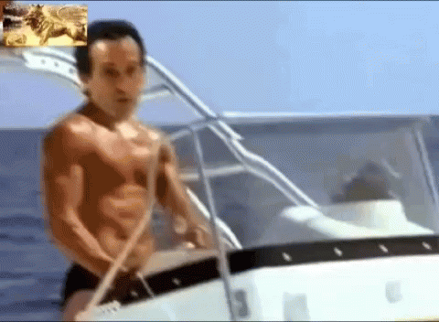 Man Without Shirt Sitting on Boat in Water