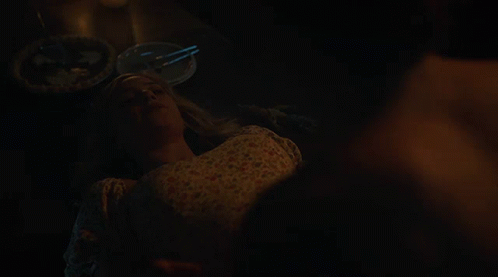 Man Without Shirt Sitting On Woman's Lap In Dark Room GIF