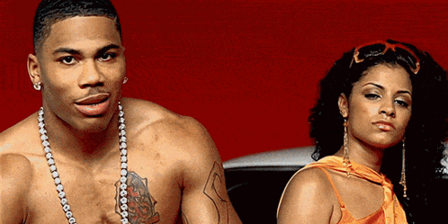 Man Without Shirt Standing Next to Woman