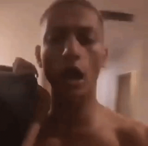 Man Without Shirt Taking Selfie