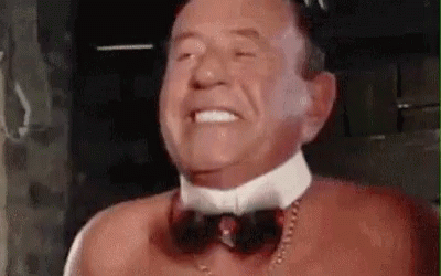 Man Without Shirt Wearing Bow Tie and Necklace