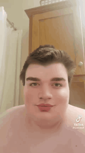 Man Without Shirt With TikTok on Chest