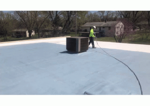 Man Working On Roof With Hose Attached GIF